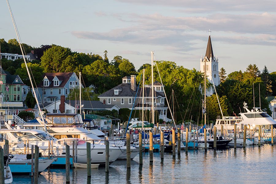 About Our Agency - View Of Dock and Boats in a Harbor in Lake Michigan at Dusk